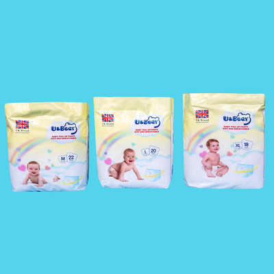 El bebé blanco del ADL levanta los pantalones que la absorbencia estupenda orgánica levanta los pañales impresos